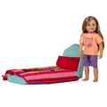 18-inch doll beside bed with harmony bedding on top