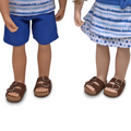 girl and boy doll wearing brown strappy sandals