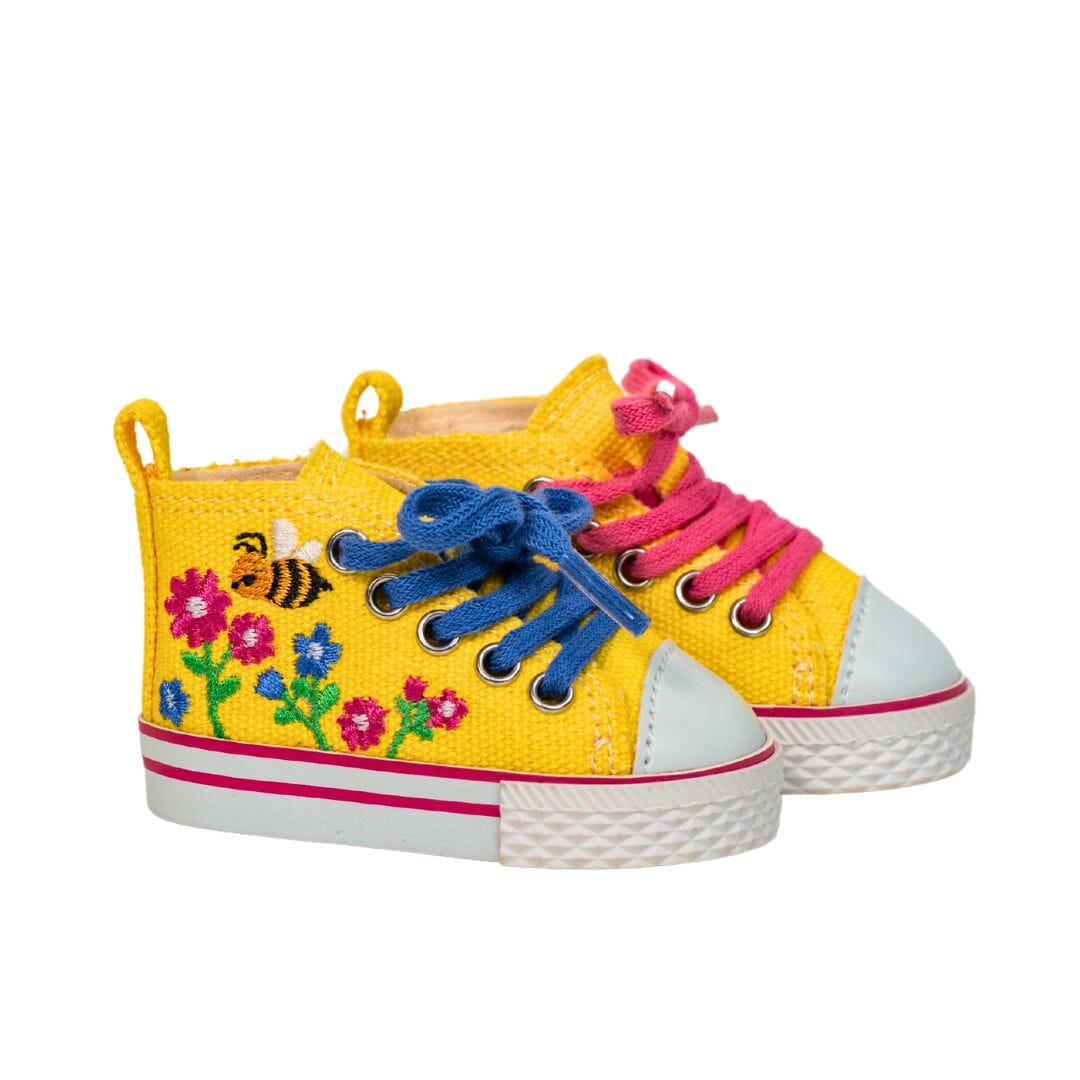 Bright yellow high top runners for dolls are embroidered with colourful flowers and buzzing bee