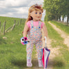 Cute Canadian outfit on Maplelea 18-inch doll in floral capri overalls with pink t-shirt, wearing matching headband, clear rain boots, holding bouquet and multicolour umbrella