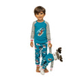 boy and moose plush wearing winter themed sledding pajamas.