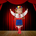 18-inch doll wearing Ukrainian dance outfit on a stage background