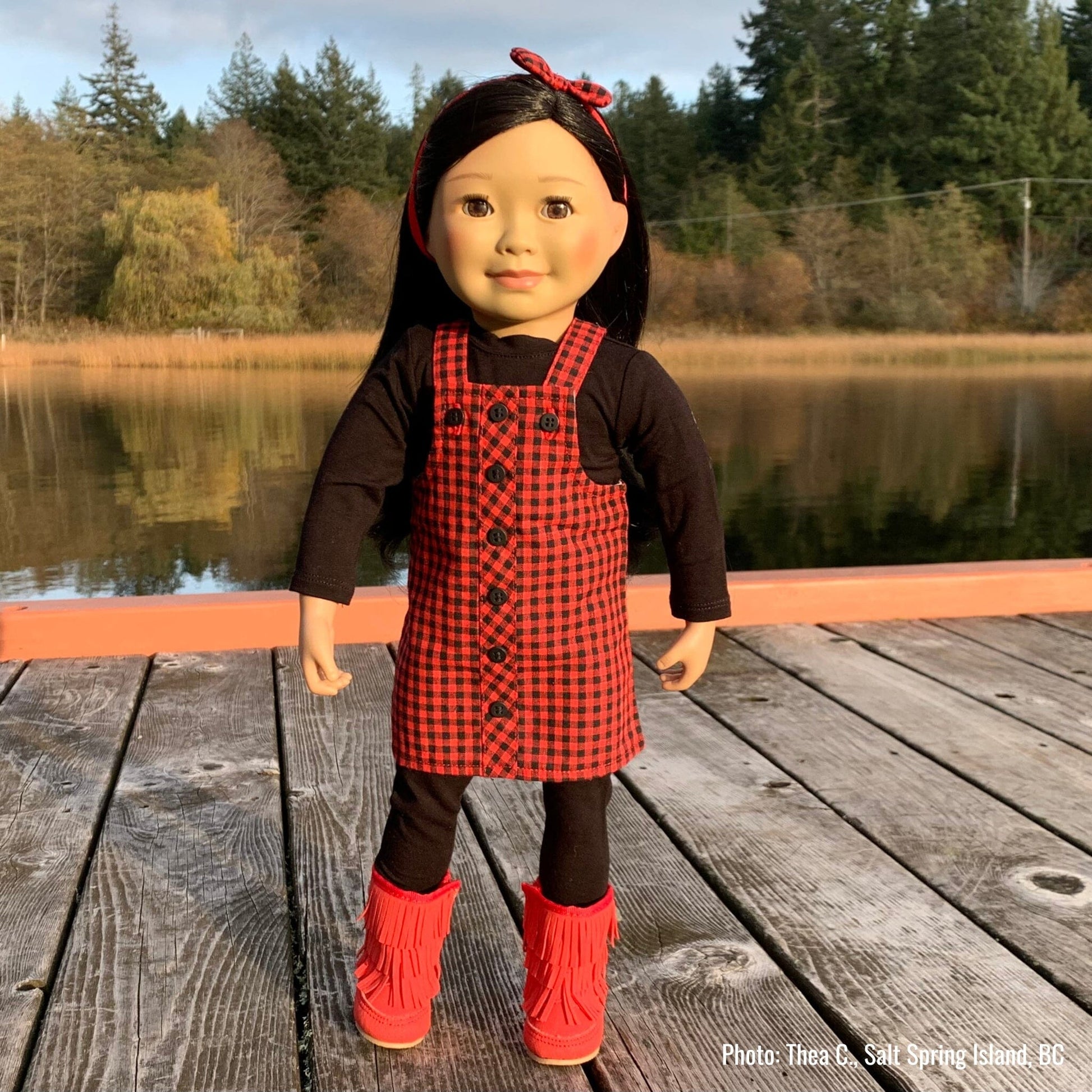 18-inch doll wearing rural roots dress set on a dock