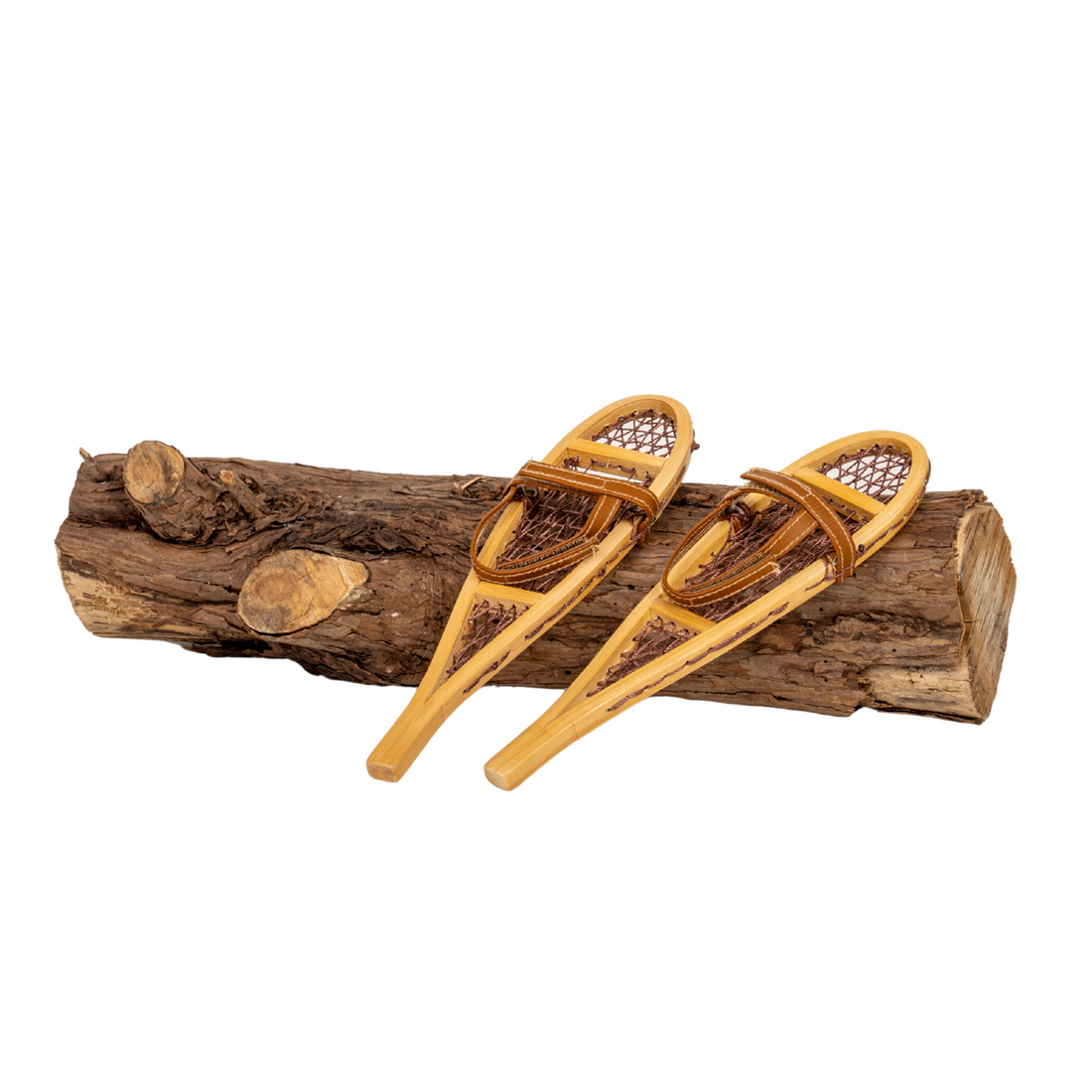 Two wooden snowshoes for 18-inch dolls on a log.