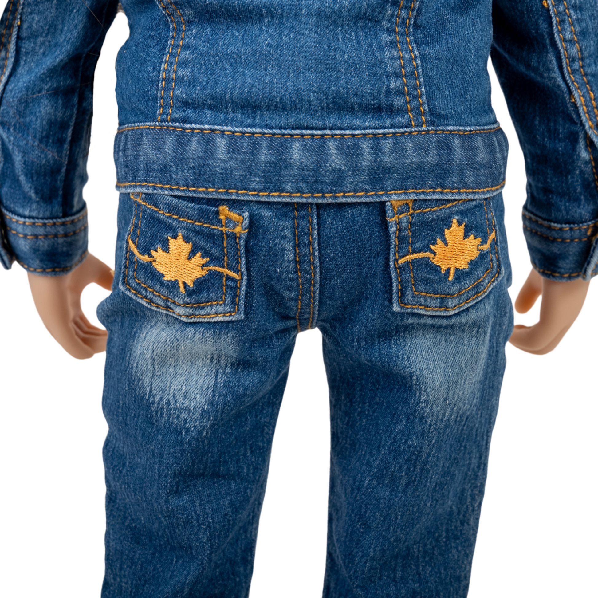 Close-up of blue jeans with embroidered maple leaves on back pockets for 18-inch dolls.