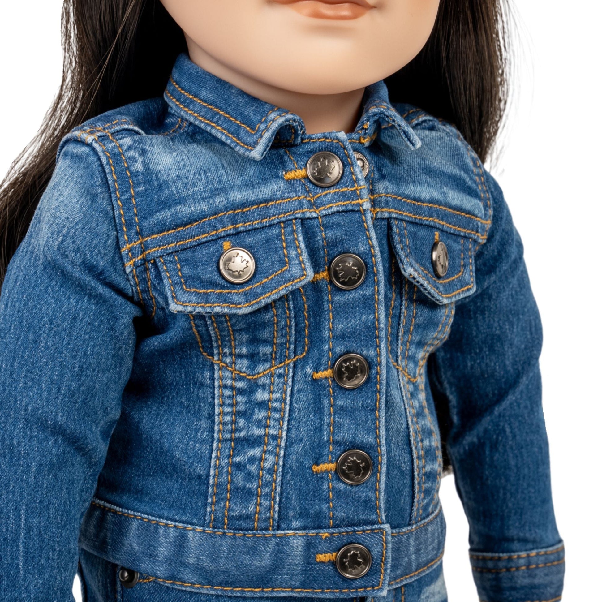 Close-up of a doll wearing a blue denim jacket with buttons.