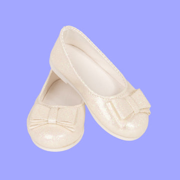 Pair of white 18-inch doll shimmer slip-on shoes.