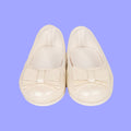 Pair of white 18-inch doll shimmer slip-on shoes.