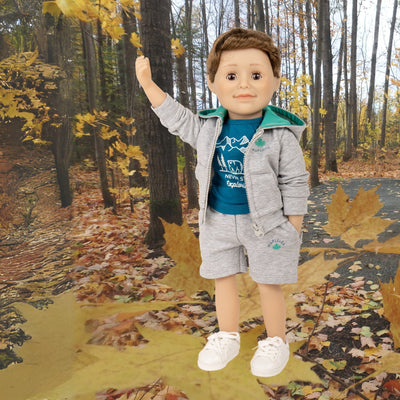 Maplelea boy doll wearing grey camping hoodie with matching teal graphic t-shirt, shorts and runners