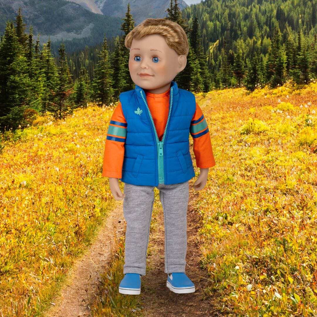 Canadian boy doll has short blonde hair, blue eyes, and comes in tee, track pants, vest and shoes.