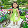 18-inch doll wearing green garden dress with silver shimmer shoes and matching  glistening butterfly purse.