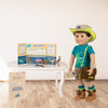 18 inch boy doll wearing dinosaur outfit showing paleontologist set on table