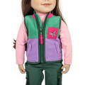 Doll wearing a colourful purple and green vest with a pink butterfly patch.