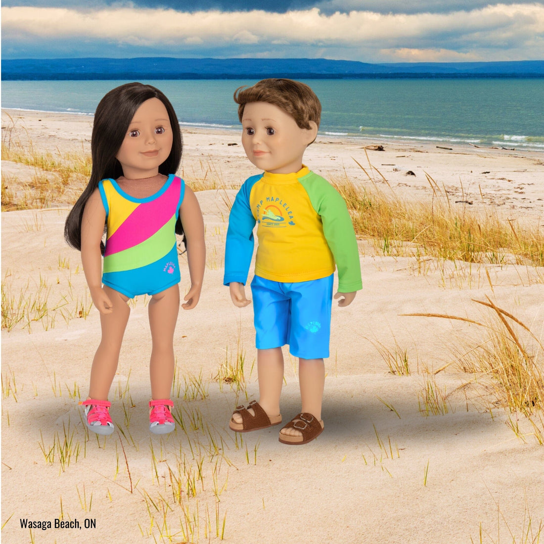 Cute dark hair dark complexion Maplelea doll wearing multicolour one piece swimsuit and watershoes.