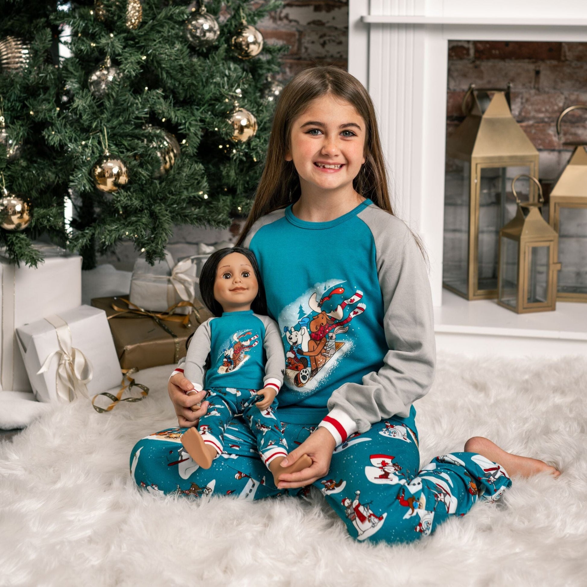 girl and her girl doll wearing matching slippery slope pajamas