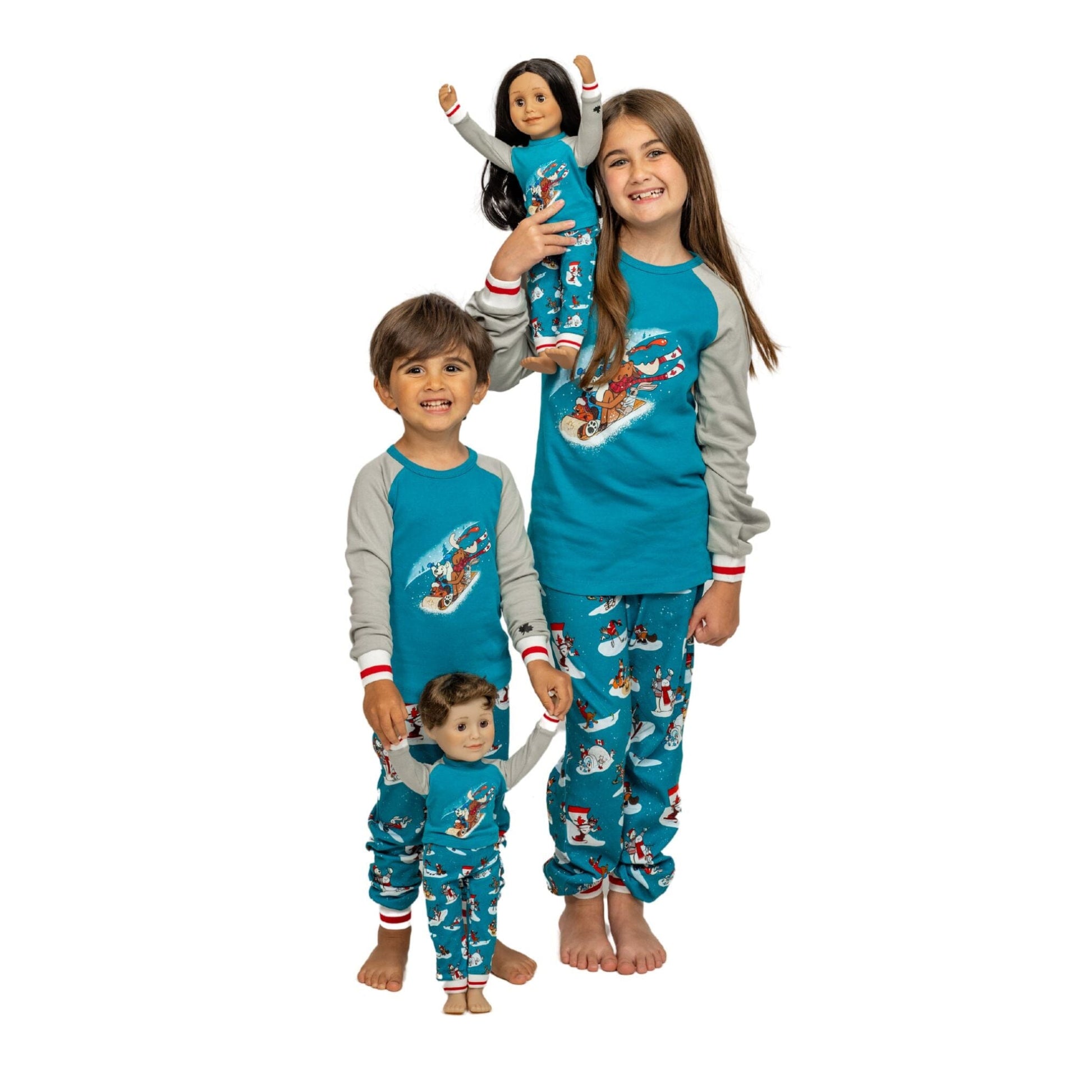 girl and boy holding there dolls in matching slippery slope pjs