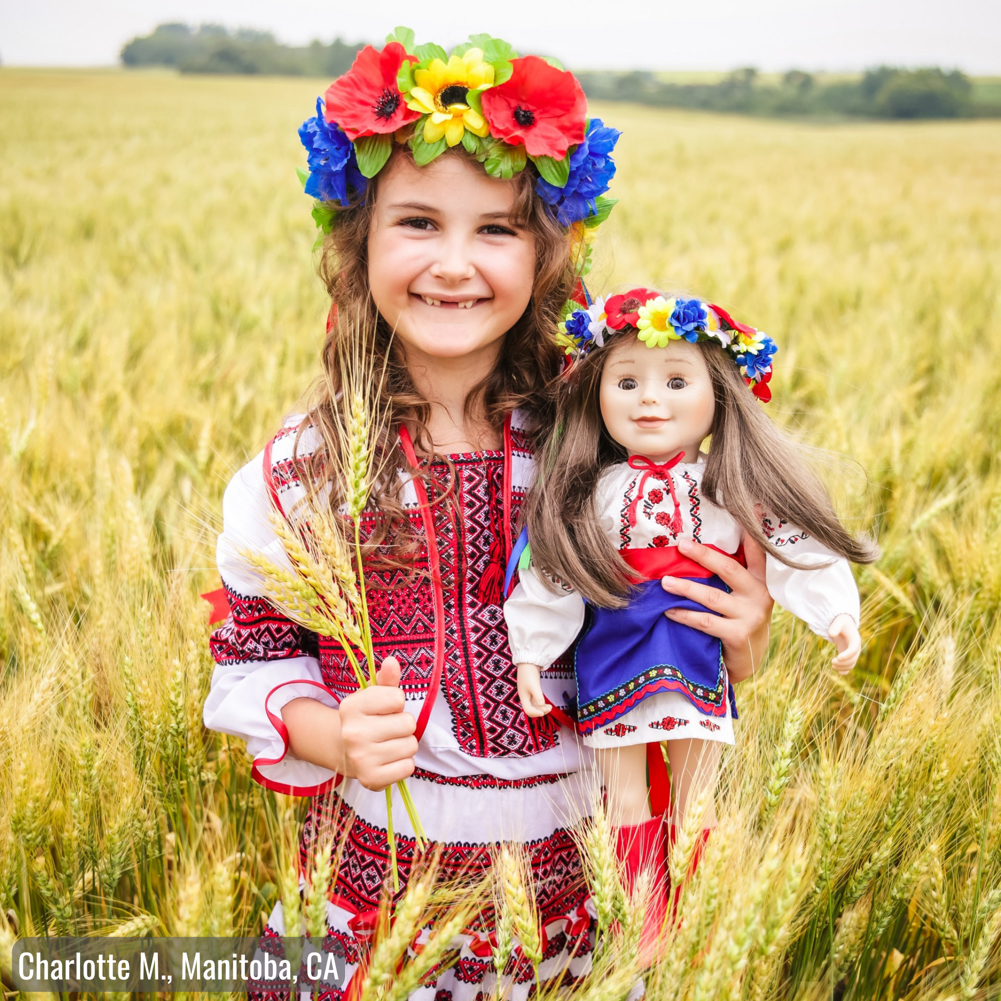 girl holding 18-inch doll wearing Ukrainian dance outfits