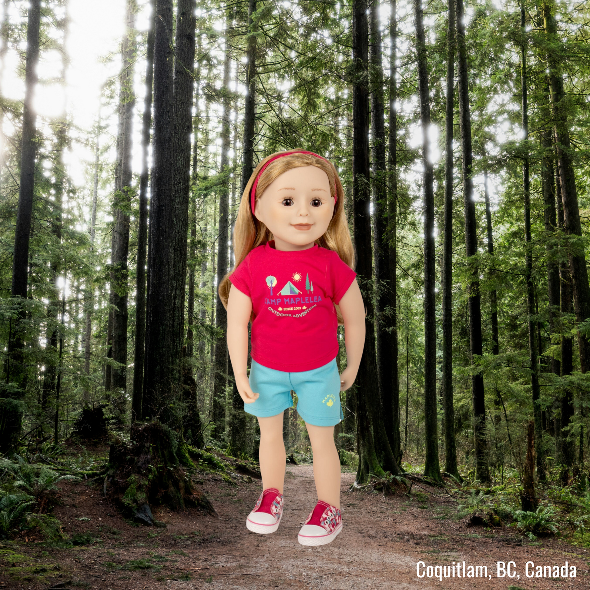 18-inch doll wearing teal shorts and pink t-shirt standing in the trees