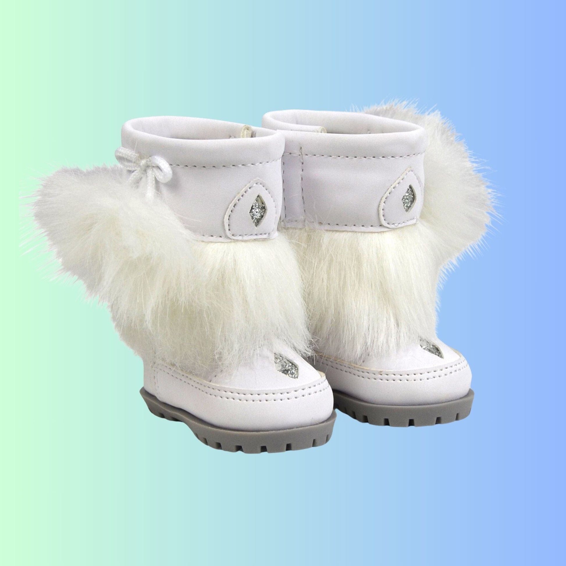 Furry white winter boots for 18 inch dolls trimmed with faux fur grey soles and silver stitching.