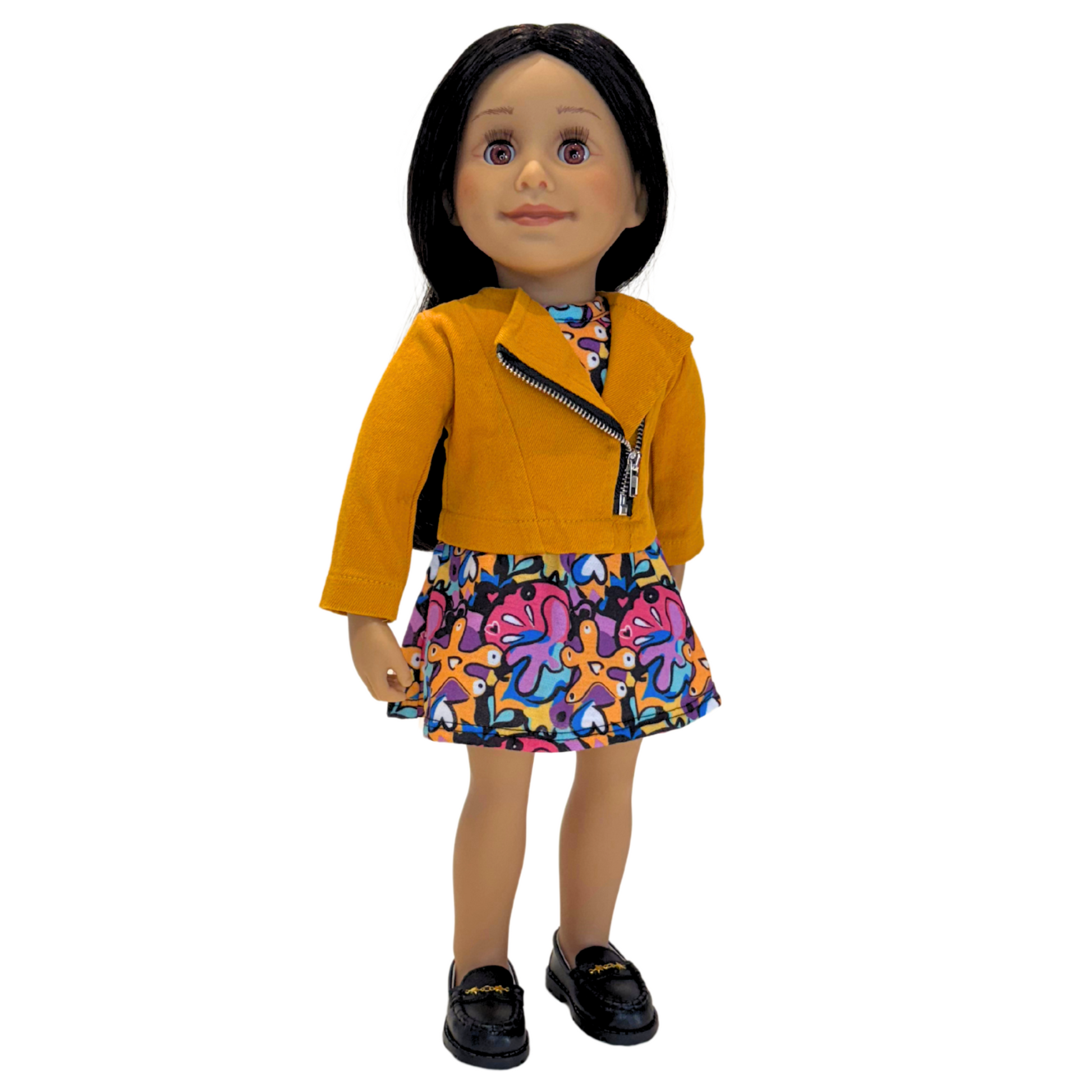 Alexi doll wearing thick chunky black loafers and multicoloured patterned dress and jacket.
