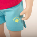 18-inch doll wearing maplelea aqua camp shorts for all maplelea with logo