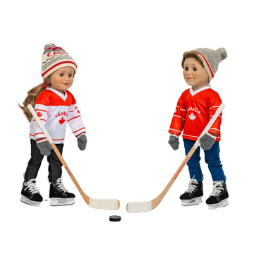 Two 18-inch dolls wearing Canadian hockey jerseys playing hockey, wearing hockey skates.