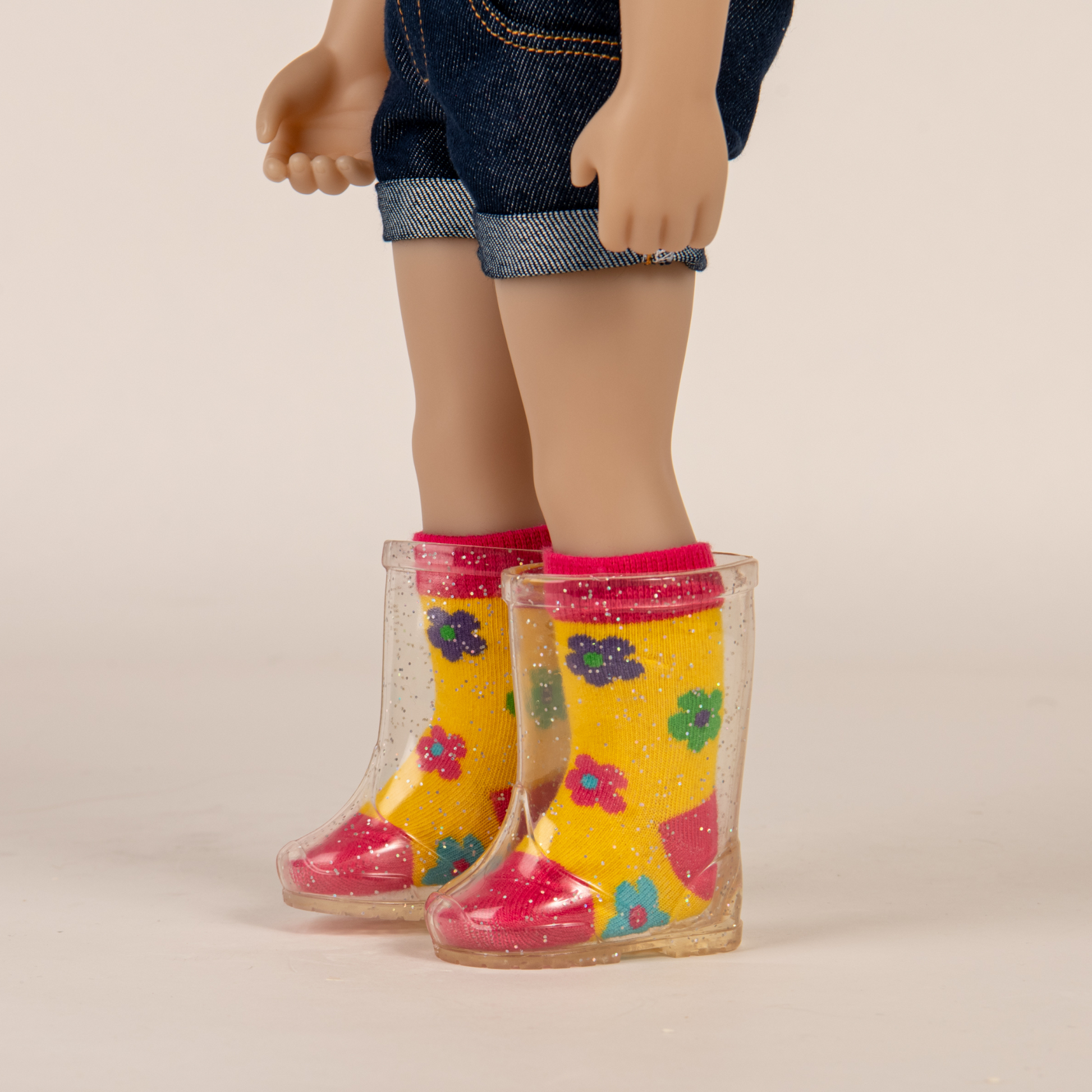 Clear sparkly rain boots with yellow pink and blue socks fit all 18 inch dolls.
