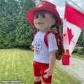 18-inch doll wearing canadian themed red shorts, bucket hat, shirt with true north strong and free emblem, and backpack with embroidered mapleleaf.