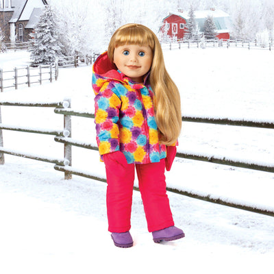 Winter scene with blonde 18 inch girl doll wearing a warm snowsuit and snow pants with boots and mitts on a farm in Manitoba