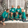 a family wears matching Christmas pajamas