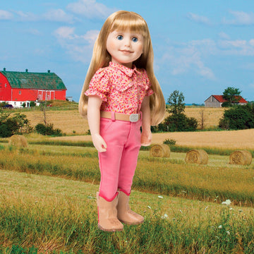 Brianne with story journal in pink patterned button-up shirt, pants, beige belt and beige boots.