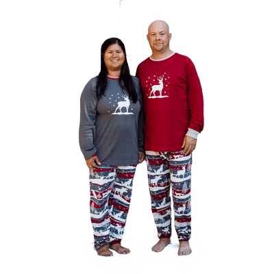 Two adults wearing matching family pjs with winter theme