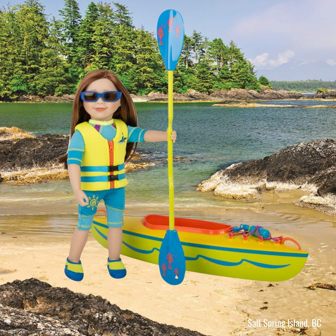 18-inch doll charlsea wearing two-piece sparkly green bathing suit with blue trim. With extra two-tone blue wetsuit with sun graphic and pink accent on the side.