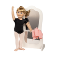 A doll with blonde hair, blue eyes, and a black leotard with pink tights poses in front of a white arched mirror stand, holding a pink towel. The doll is shown against a plain white background.