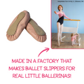 A pair of pink ballet slippers with tan suede-like tops, shown alongside a lifestyle inset of a young ballerina practicing at a barre. Text at the bottom reads, 'MADE IN A FACTORY THAT MAKES BALLET SLIPPERS FOR REAL LITTLE BALLERINAS!' with a brand name, 'Maplelea Fan Emily S.