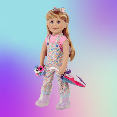 Maplelea 18-inch doll in floral capri overalls with pink t-shirt, clear rain boots holding bouquet and multicolour umbrella