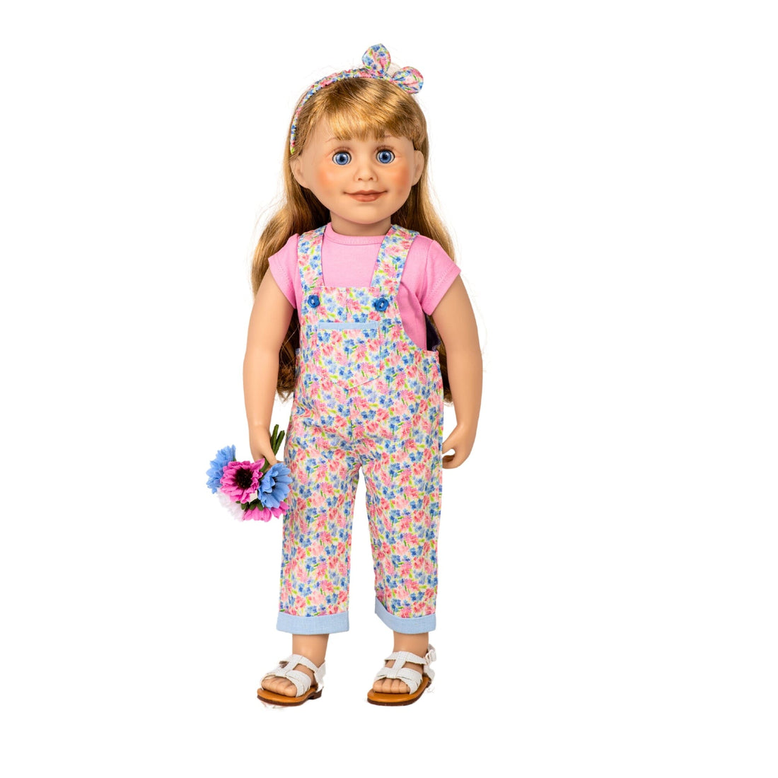 Blonde Maplelea 18 inch girl doll Brianne is wearing pink and blue overalls, hairband and tshirt.