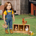 18-inch doll in overalls standing next to a wooden coop with chickens and eggs on a farm setting.