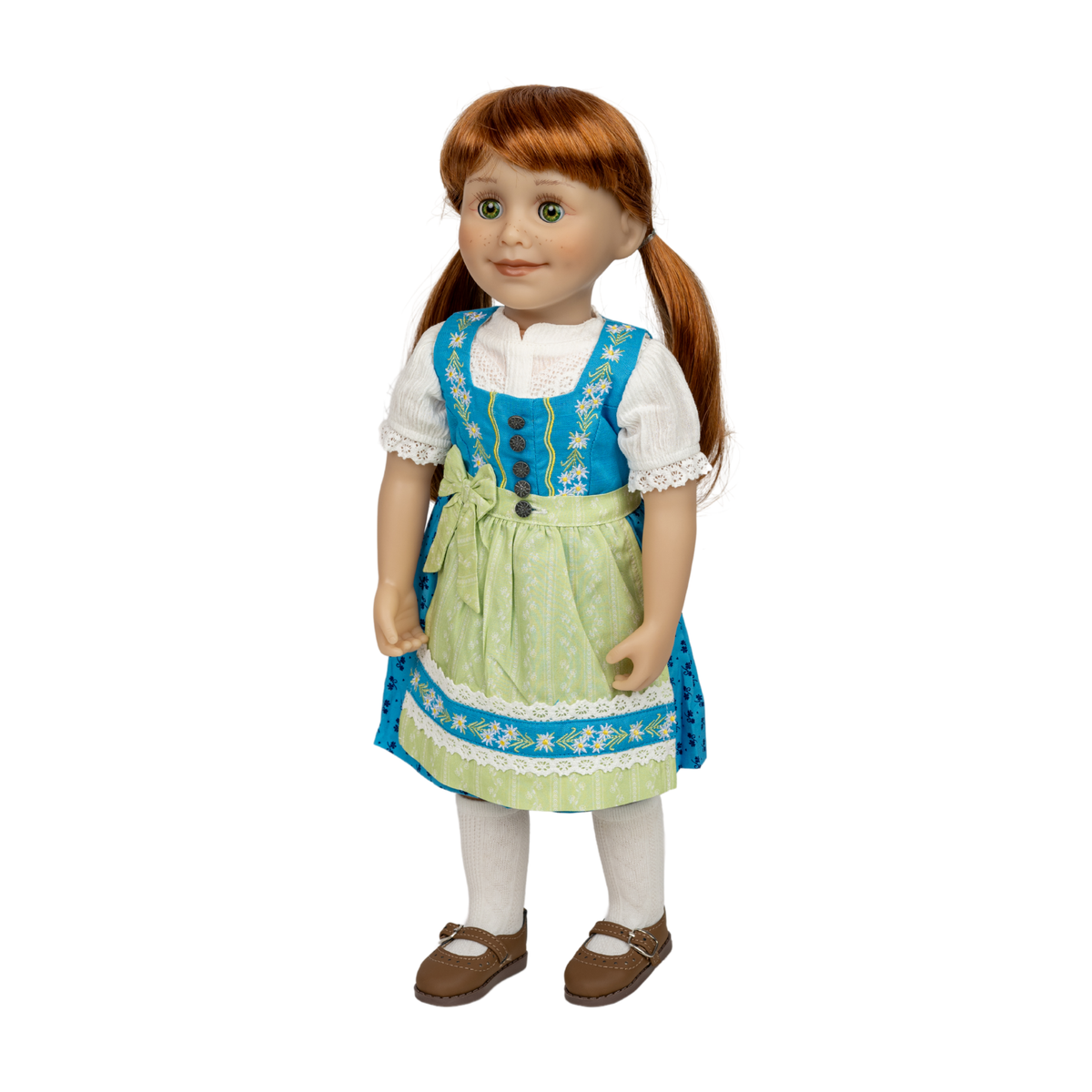 A doll with red hair in pigtails wearing a blue and light green traditional-style dress with white sleeves, white tights, and brown shoes, photographed against a plain white background. Edelweiss Dirndl Set traditional German outfit for 18-inch dolls by Maplelea KJ26