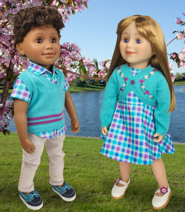 boy doll and girl doll wearing spring outfits amid cherry blossom trees. Party dress and matching vest set.