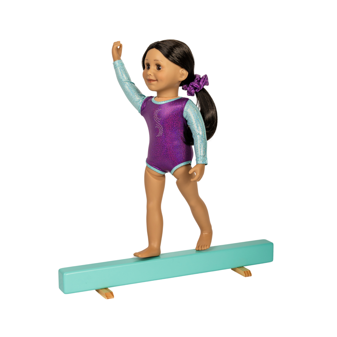 An 18-inch gymnast doll with dark hair in a purple scrunchie, wearing a purple and light blue leotard, balancing on a mint green balance beam Maplelea Doll playset Ballet. Toy gift