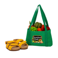 A green fabric tote bag filled with colourful felt vegetables, shown next to a pair of yellow felt sandals on a plain white background. The bag has a front patch that reads 'Farmstand Fresh'.