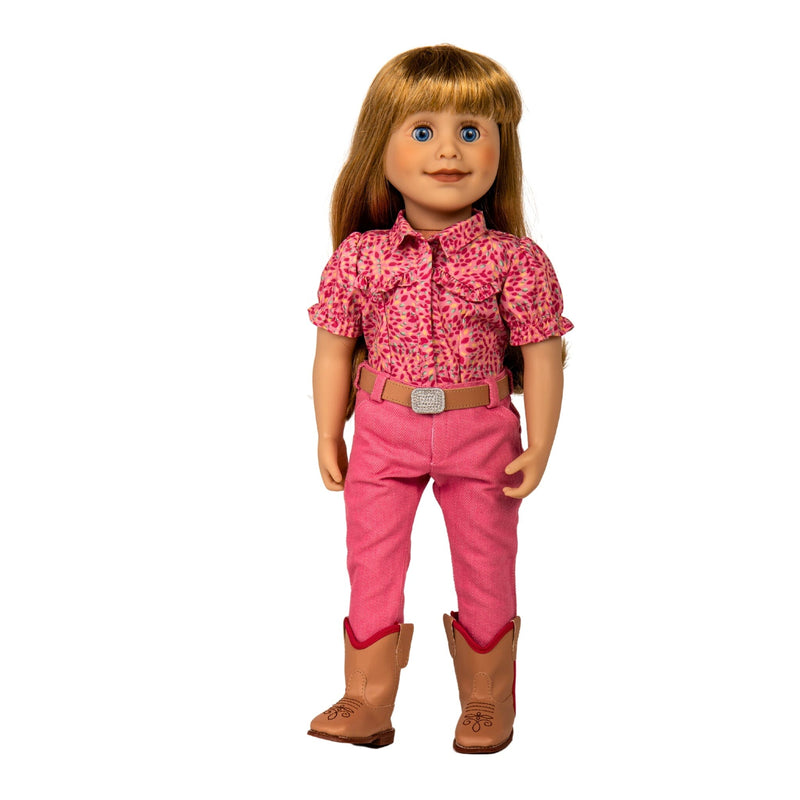 Maplelea 18 inch doll Brianne with story journal wearing pink patterned button-up shirt, pink pants, beige belt with sparkly buckle and beige riding boots. Shown in a Manitoba farm field.