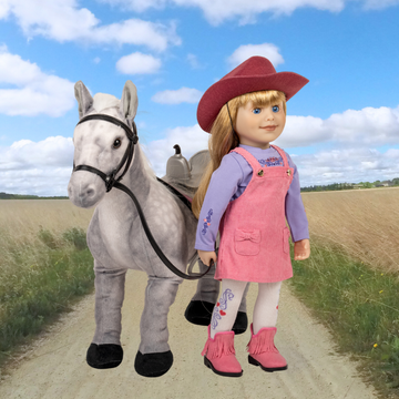18-inch doll in pink outfit with cowboy hat standing next to a toy horse on a dirt road with a blue sky in Manitoba.