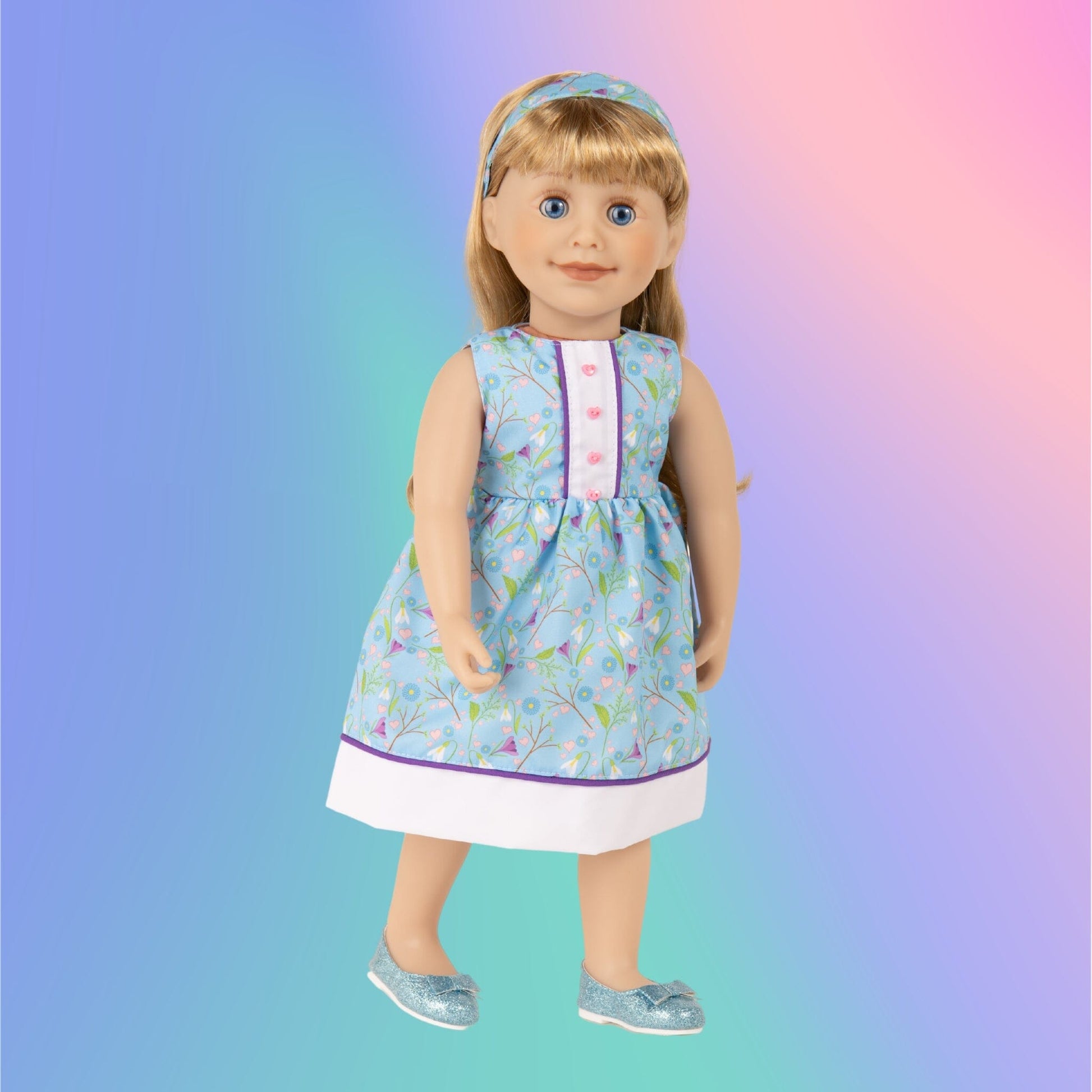 Maplelea Brianne doll wearing blue crocus dress with heart buttons hairband and sparkly blue shoes