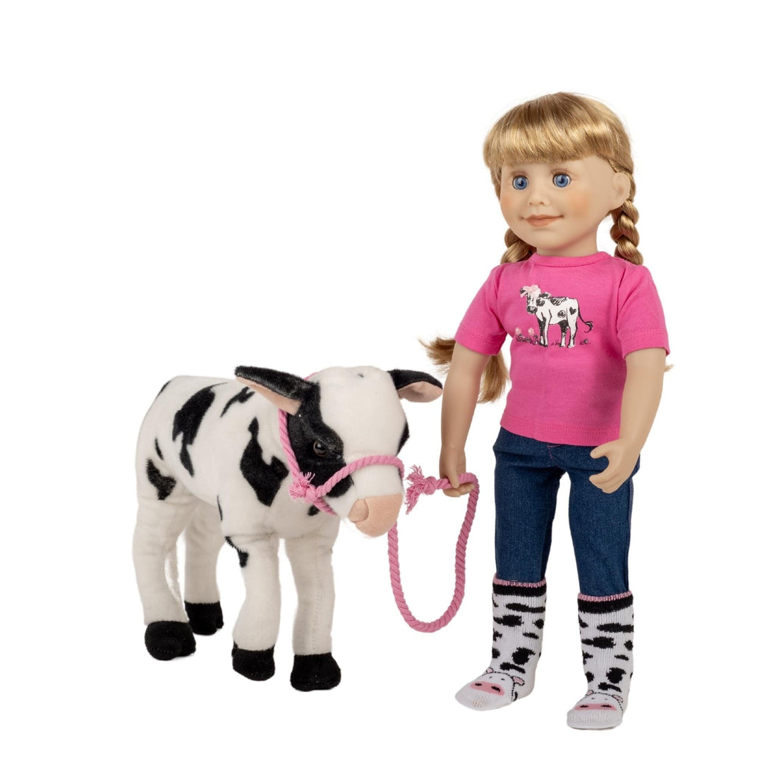 black and white cow soft toy with doll dressed in a pink tshirt with embellished calf graphic, blue jeans and calf print socks.