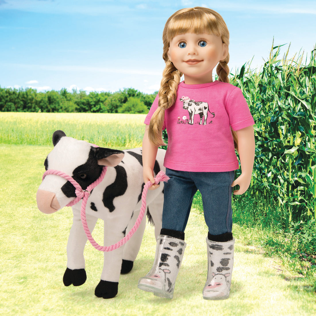 black and white cow soft toy with doll dressed in a pink tshirt with embellished calf graphic, blue jeans and calf print socks.