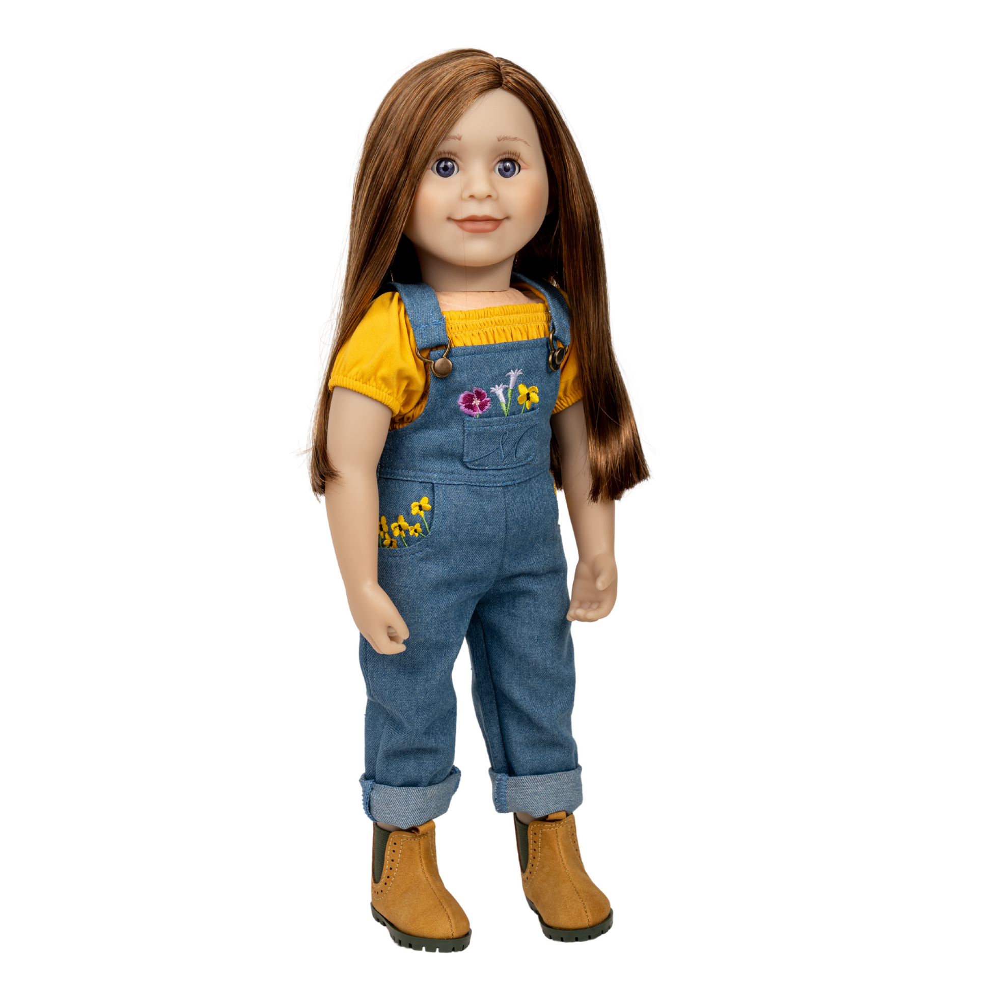 18-inch doll wearing a yellow shirt and blue denim overalls with floral embroidery with golden boots.