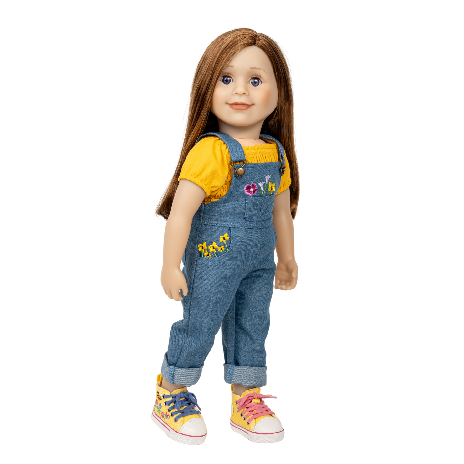 18-inch doll wearing a yellow shirt and blue denim overalls with floral details. embroidered runners are on the doll's feet.