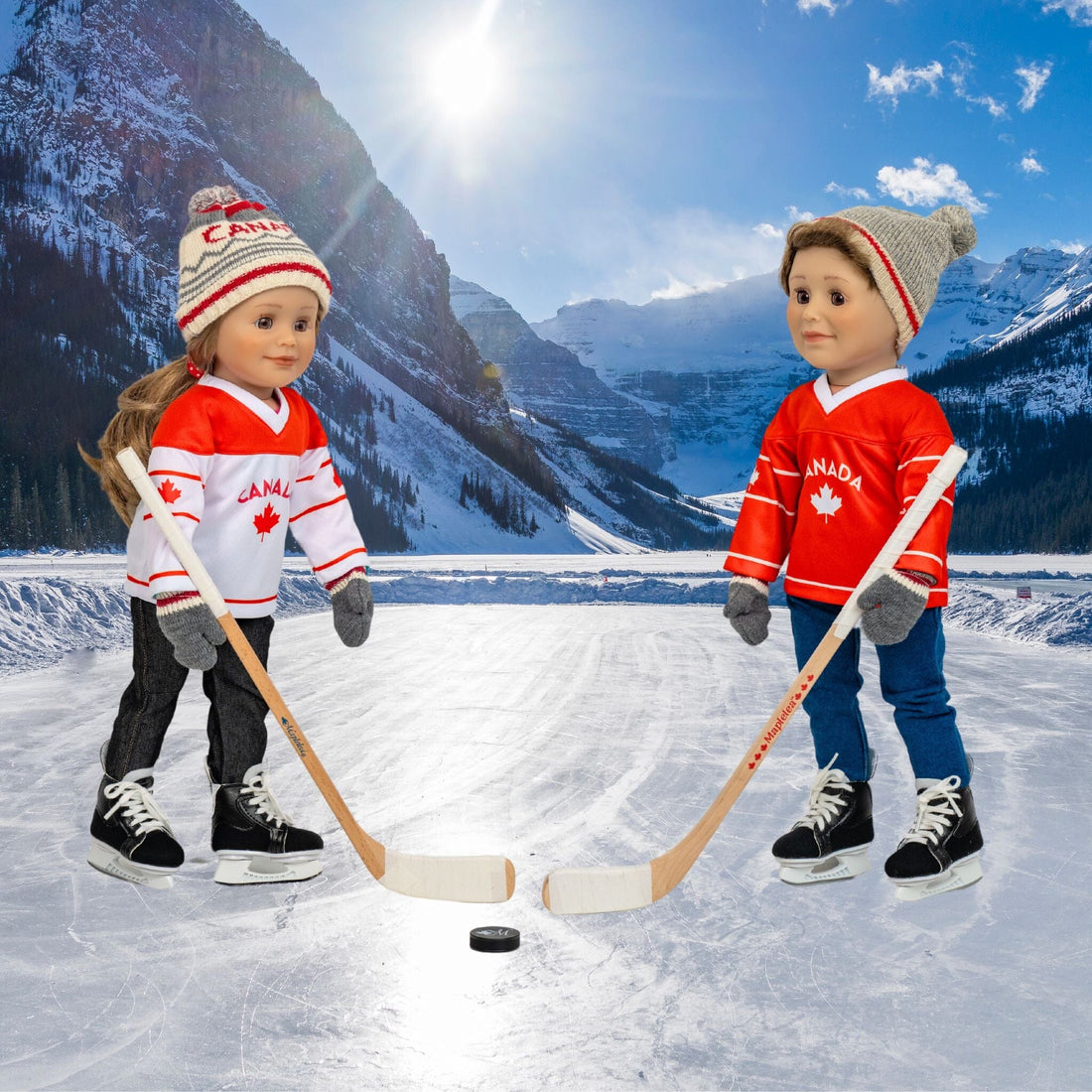 Two 18-inch dolls wearing Canadian hockey jerseys playing hockey, wearing hockey skates.